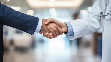 A warm handshake between a doctor and a professional signifies partnership photo