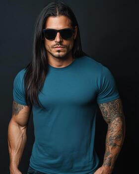 A model poses confidently in a blank t-shirt against a dark backdrop photo