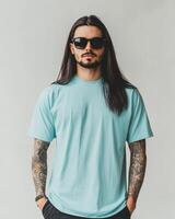 A stylish model displays a plain t-shirt against a simple backdrop photo