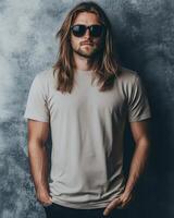 A handsome model poses confidently wearing a blank t-shirt and sunglasses photo