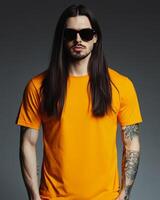 A male model presents a vibrant t-shirt with confidence and style photo