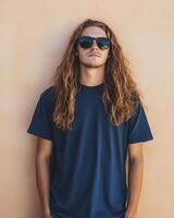 Man with long hair poses confidently in a blank t-shirt and sunglasses photo