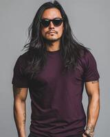 A handsome model with long hair poses confidently in a casual t-shirt photo