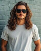 Confident young man showcases a plain t-shirt with an urban vibe photo