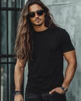 A stylish man poses in a black t-shirt, exuding charm and confidence photo