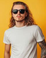Young man exudes coolness, showcasing a blank t-shirt and stylish sunglasses photo