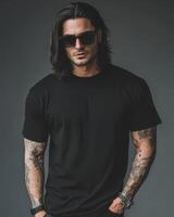 Stylish model poses confidently in a blank t-shirt, showcasing his tattoos photo