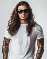 A handsome model showcases a blank t-shirt with a bold look and tattoos photo