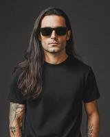 Model with long hair poses confidently in a blank t-shirt and sunglasses photo