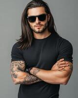 Model displays a sleek black t-shirt with confidence and attitude photo
