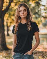 A woman stands in a forest clearing, radiating confidence in her black tee photo