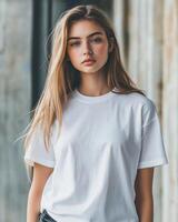 A female model elegantly poses in a blank white t-shirt against urban architecture photo