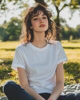 A young woman enjoys a sunny day outside while wearing a plain t-shirt photo