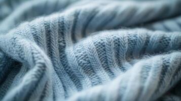 A soft, textured blue blanket lies elegantly, inviting warmth and comfort photo