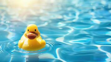 A yellow rubber duck is floating in a pool of water photo