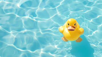 A yellow rubber duck is floating in a pool of water photo