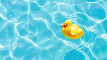 A yellow rubber duck is floating in a pool of water photo