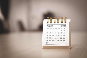Calendar page August of the year 2025 white color in meeting room in office. with copy space and business design. concept of planning and setting new strategic goals. photo
