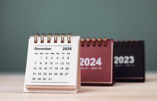 Calendar page December of the year 2025 white color on green background. with copy space and business design. concept of planning and setting new strategic goals. photo