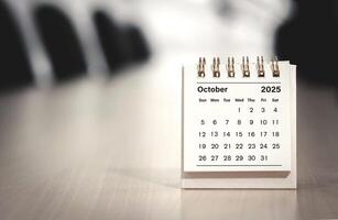 Calendar page October of the year 2025 white color in meeting room in office. with copy space and business design. concept of planning and setting new strategic goals. photo