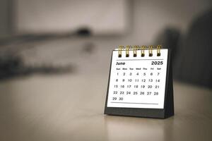 Calendar page June of the year 2025 white color in meeting room in office. with copy space and business design. concept of planning and setting new strategic goals. photo