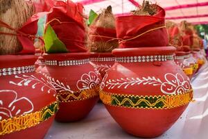 Kalash with coconut and mango leaf with floral decoration earthen pots containing sacred water. Kalash for hindu puja during Jagannath Temple Mangal Kalash Yatra, front view, closeup photo