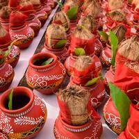 Kalash with coconut and mango leaf with floral decoration earthen pots containing sacred water. Kalash for hindu puja during Jagannath Temple Mangal Kalash Yatra, front view, closeup photo