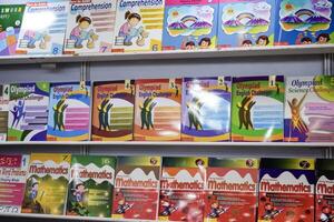 New Delhi, India, July 17 2024 - Variety of Books on shelf inside a book-stall at Delhi International Book Fair, Selection of books on display in Annual Book Fair at Bharat Mandapam complex photo