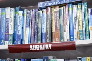 New Delhi, India, July 17 2024 - Variety of Books on shelf inside a book-stall at Delhi International Book Fair, Selection of books on display in Annual Book Fair at Bharat Mandapam complex photo