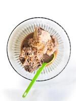 Konro soup is a typical Bugis-Makassar food made from beef ribs or bones wrapped in beef cooked with spices, and served warm, a bowl of kondro soup isolated on a wooden press and white BG photo