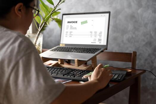 Accountant Using E Invoice Software At Computer In Office. Online digital e-invoicing and statement software. Financial accounting concepts. photo