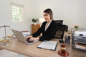 Female Lawyer Reviewing Contract Documents in Modern Office Setting for Legal Case Analysis photo