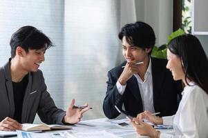 Diverse Team of Business Professionals Collaborating and Sharing Ideas in a Modern Office Setting photo