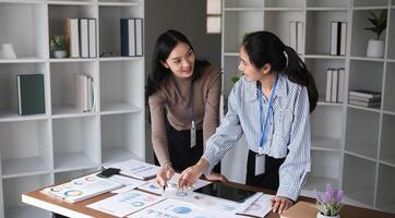 Team of Accountant Collaborating and Exchanging Ideas in Modern Office Environment with Charts and Graphs photo