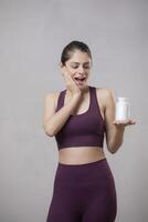 Beautiful Model Has A WOW Expression On Her Face While Holding A Pill Bottle In Her Hand photo