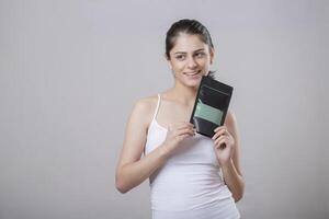 Smiling Model Looking To The Side While Holding A Face Mask Sachet photo