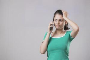 A Sweet Model With Shocked Face Expression While Talking On Phone With Someone photo