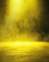 A spotlight shines down on a yellow foggy stage. photo