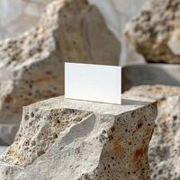 A blank business card on a rough marble podium. photo