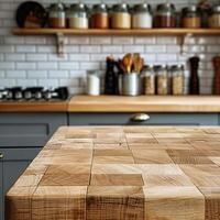 A wooden table made of small blocks with a blurred background of a kitchen. photo