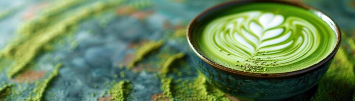 Matcha green tea in a bowl on a blue background photo