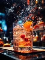 A glass of whiskey with a splash of orange juice and a cherry. photo