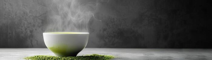 A bowl of hot matcha green tea with steam rising from it. The bowl is sitting on a bed of matcha powder. photo