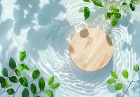 Round wooden podium with green leaves and shadows on the water surface. photo