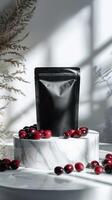Black matte food bag mockup with red berries on marble podium. photo