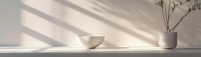 a still life with a bowl and a vase on a table with soft lighting photo