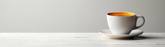 A white coffee cup on a white saucer sits on a white table against a white background. photo