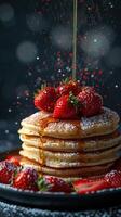 A decadent stack of pancakes topped with fresh strawberries and drizzled in maple syrup. photo