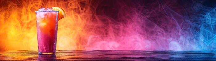 A refreshing cocktail with a slice of orange on a table with colorful smoke in the background photo