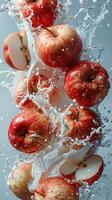 Red apples falling in water photo